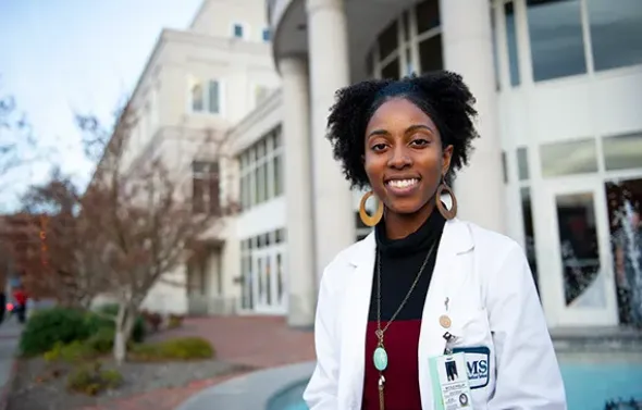 An EVMS student sits in front of the Brickell Medical Scienc