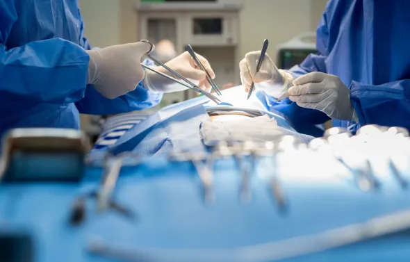 Surgeons performing a procedure in an operating room.