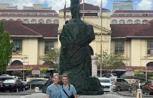 Two fellows in front of naked male stature
