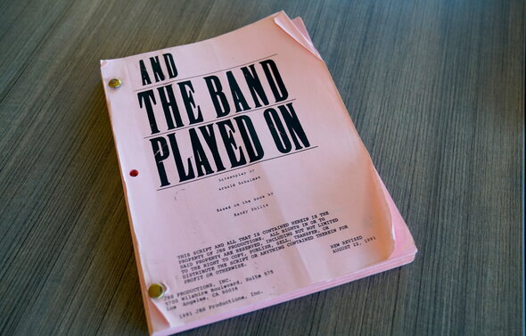 Photo of a film script that reads "And the Band Played On." 