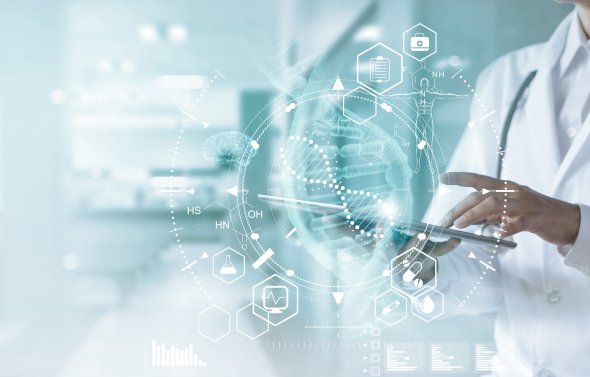 Doctor uses tablet to access electronic medical record.