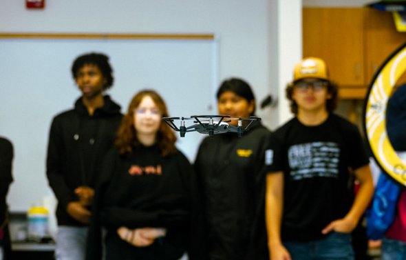 Students watching a drone.