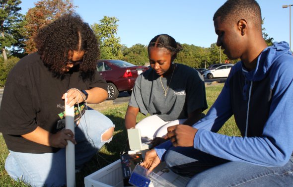 Students setting up a land sensor