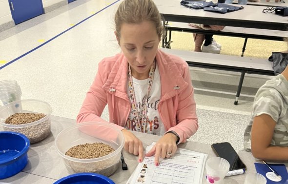 An educator doing a hands-on activity with students.