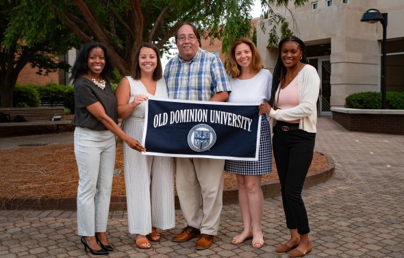 five faculty with an ODU banner