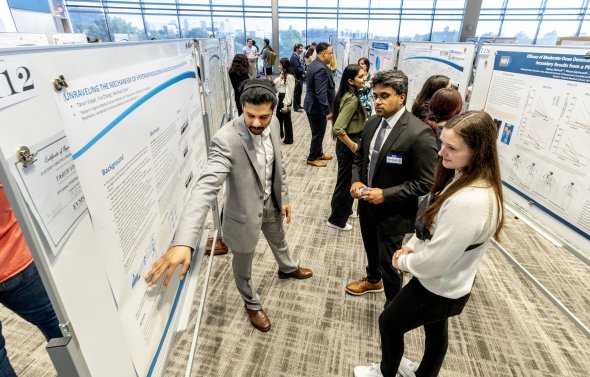 student presenting a poster at research day