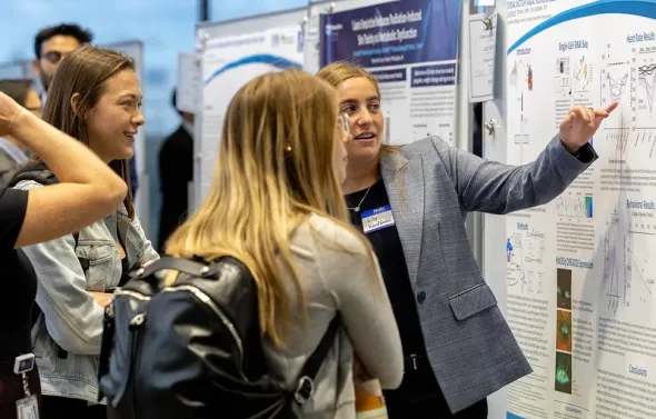 Female trainee presents her research during EVMS Research Da