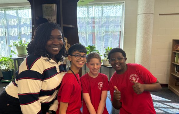 teacher and three kids smiling