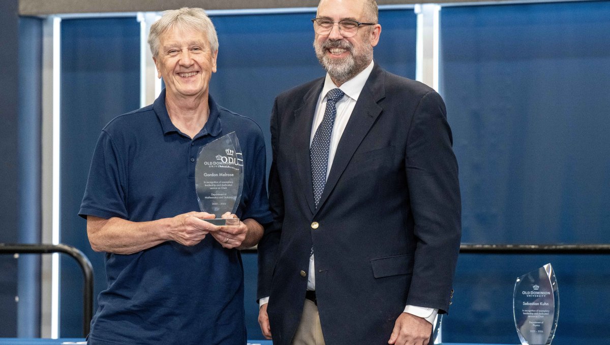 Gordon Melrose receiving an award from Provost Payne.