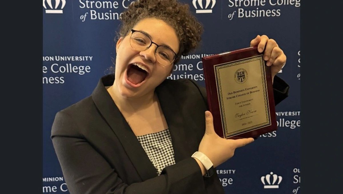 Student holding an award
