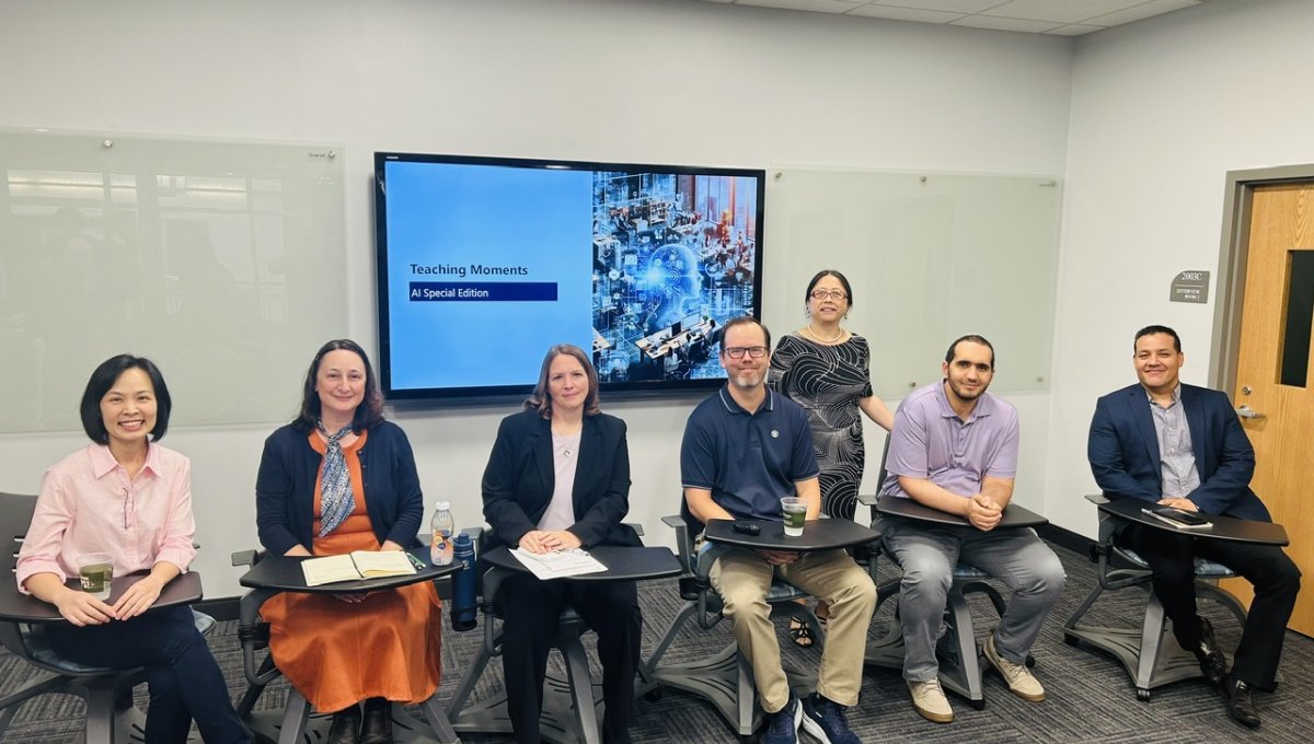 faculty sitting in front of projector