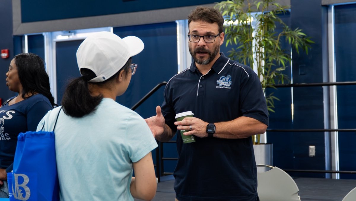 Dr. Dave Gauther from Biology talks to student about research