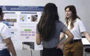 Female student explaining her presentation to two young women
