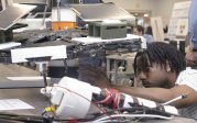 Black student adjusting his project