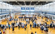 A large group of students mingle together in the student recreation center. 
