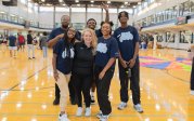 A group of people pose for a photo in the student recreation center. 