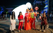 A group of people pose for a photo in their Halloween costumes.