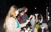 Students paint pumpkins at an event.