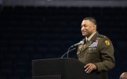 Military officer speaking at podium