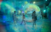 People walking through bubbles.
