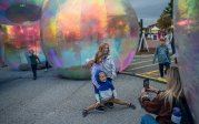 A family stops for a photo in the larger-than-life bubbles during Bubble Fest.