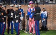 People in military uniform on the ODU football field.