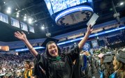 A student celebrates at commencement.
