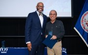 Ajay Gupta holds award while posing for picture with ODU President Brian O. Hemphill.