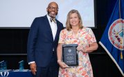 Customer Relations Employee of the Year award winner Lori Barrett with President Brian O. Hemphill at the Monarch Milestones event.
