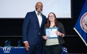 Rachael Friedenberg holds award while posing for picture with ODU President Brian O. Hemphill.
