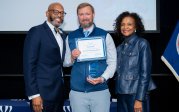 Rick French holds award while posing for picture with ODU President Brian O. Hemphill.