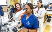 Student looks into microscope