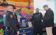 two police officers and a dog at a booth