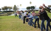 Residents catching water balloons at retreat.