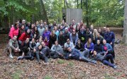 Smiling residents in woods during retreat. 