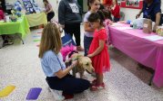 A woman and a child pet a dog.