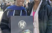 The sisters pose outside the Education Building on commencement day, with Sabrina in regalia.