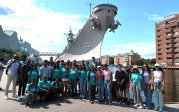  New international students posing for a picture in front of the USS Wisconsin in Norfolk