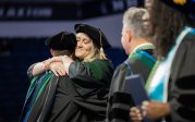 Two people hugging.