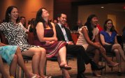 2014 graduates laughing in ballroom. 