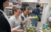 Students serving salad