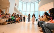 A group of people putting on a fashion show at the Barry Art Museum.