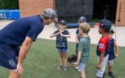 A baseball coach talks to his young players.