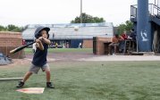 A young baseball player gets ready to swing at a pitch.