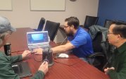 Group working on a dental research session on a laptop.