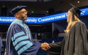President Brian O. Hemphill, Ph.D., congratulates a student