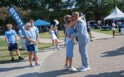 ODU head football coach Ricky Rahne shares a kiss with his wife, Jen Rahne, during the Monarch March from Webb Center to S.B. Ballard Stadium ahead of the game against North Carolina Central.