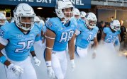 ODU football players run onto the field.