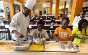 Cook and children preparing food