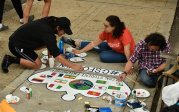 Students from the Global Student Friendship Center paint international flags on their crown. Photo Chuck Thomas/ODU